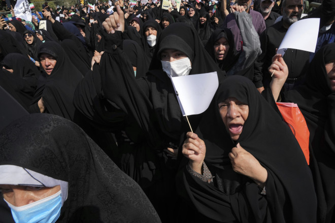 Ιρανοί φιλοκυβερνητικοί διαδηλωτές συμμετέχουν σε συγκέντρωση  για να καταδικάσουν τις πρόσφατες αντικυβερνητικές διαδηλώσεις για το θάνατο της 22χρονης Αμινί στην Τεχεράνη (AP Photo/Vahid Salemi)