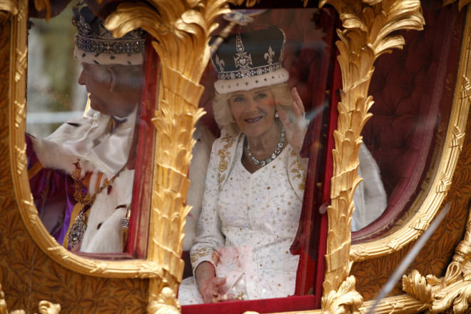 Το βασιλικό ζεύγος μέσα στη χρυσή άμαξα κατά την επιστροφή του στο Μπάκιγχαμ μετά τη στέψη του/ (AP Photo/David Cliff)