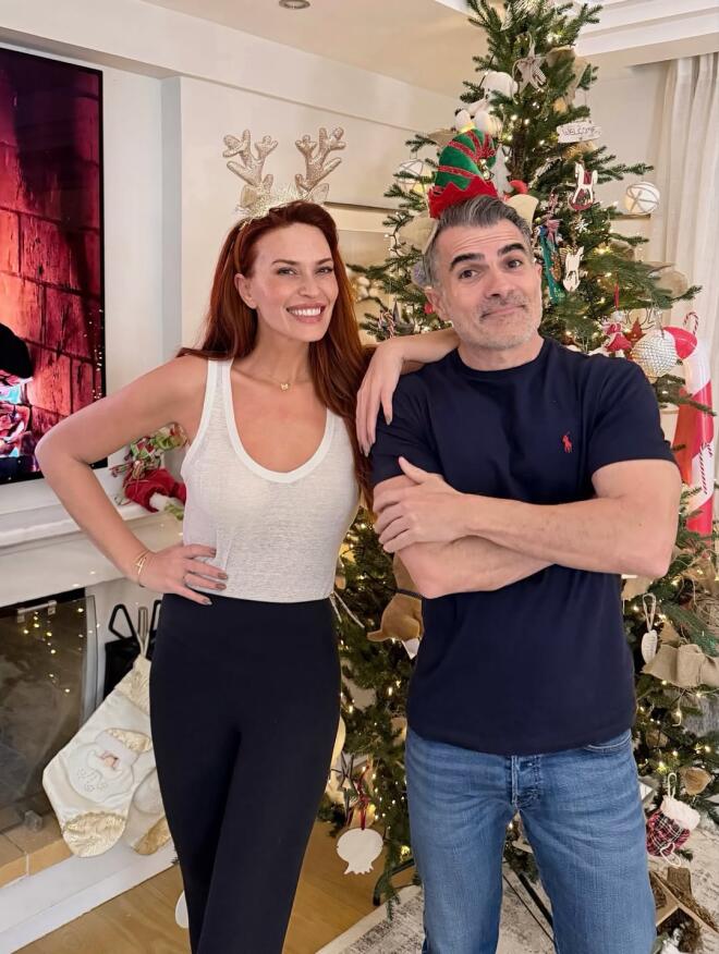 Η Σίσσυ Χρηστίδου ποζάρει μπροστά στο δέντρο μαζί με τον κουμπάρο της, Παύλο Σταματόπουλο